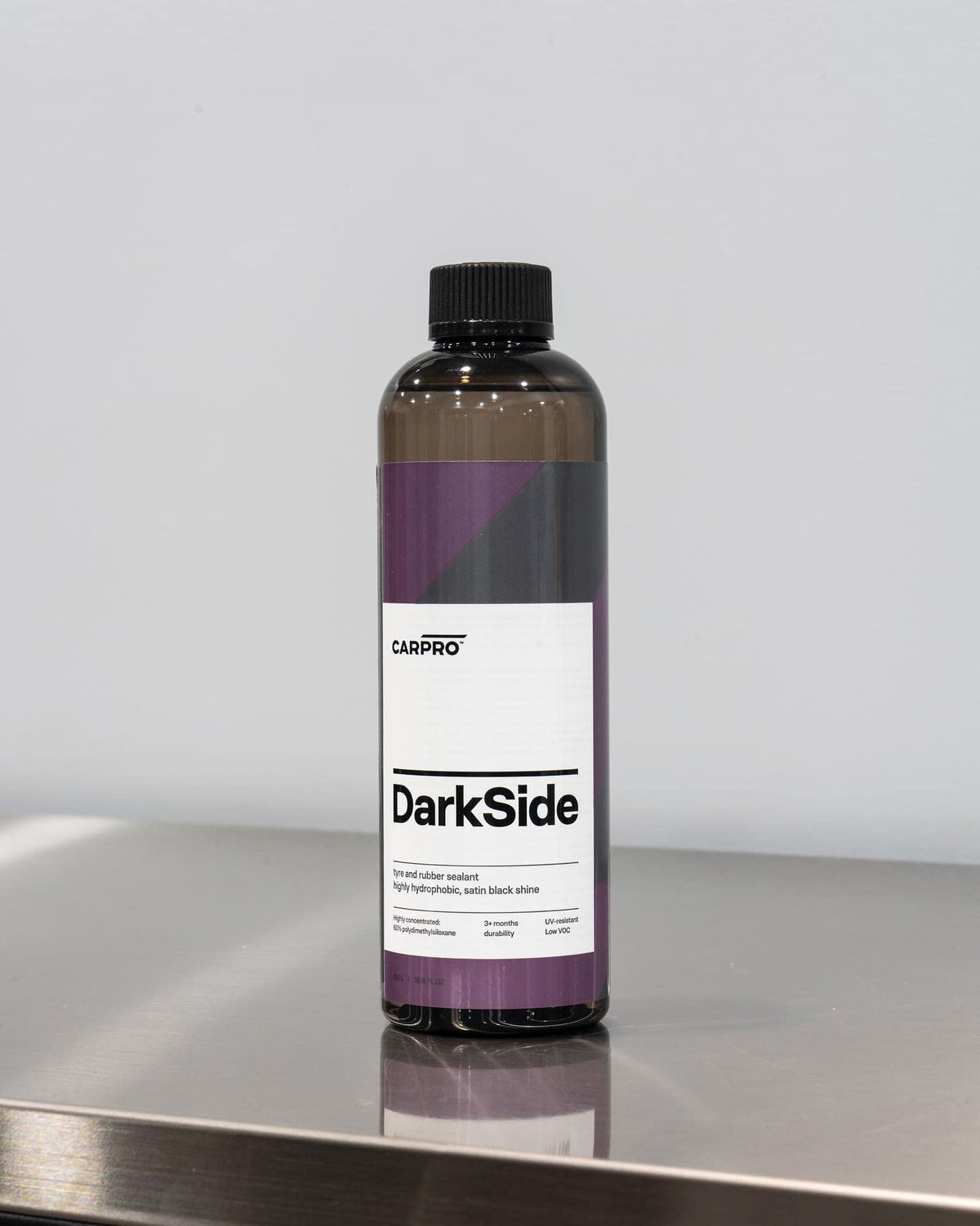 CARPRO DarkSide water beading on treated rubber showing hydrophobic dirt-shedding benefit