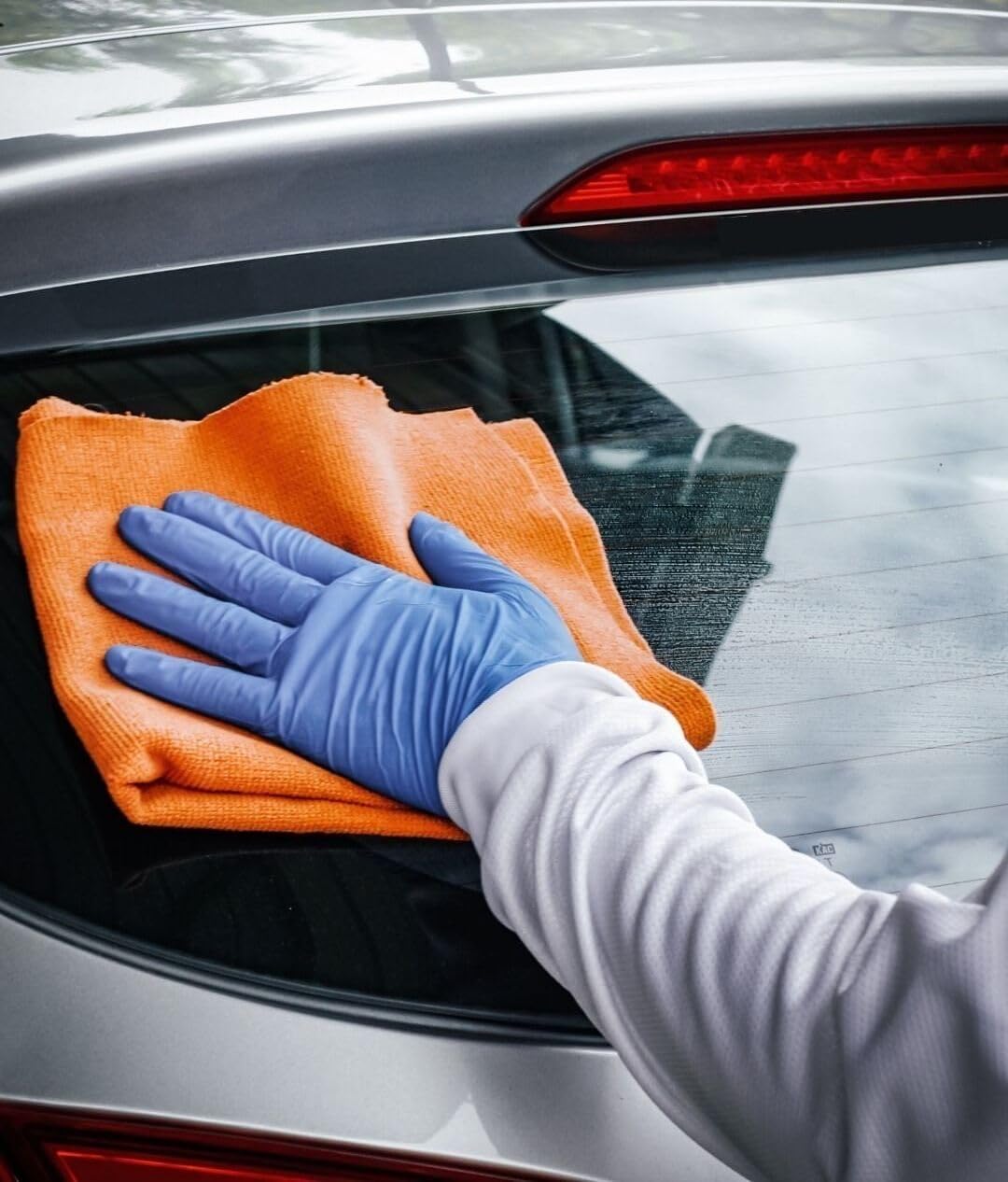 Wiping panel with microfiber showing CARPRO ECH2O lifting dirt and preventing swirl marks