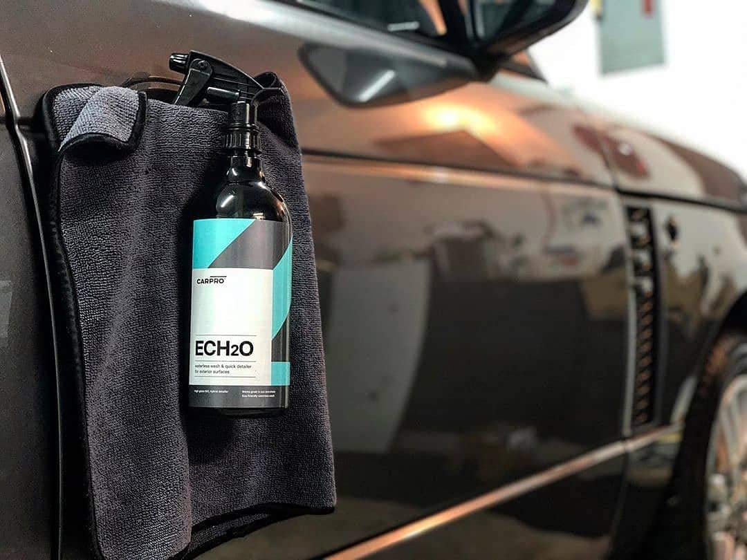 Measuring pour of CARPRO ECH2O concentrate into a spray bottle demonstrating correct dilution