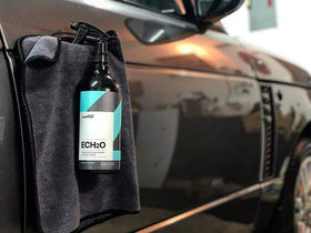 Measuring pour of CARPRO ECH2O concentrate into a spray bottle demonstrating correct dilution