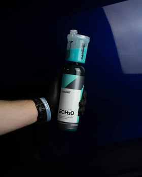 Hand holding CARPRO 500 mL bottle for scale, convenient and concentrated