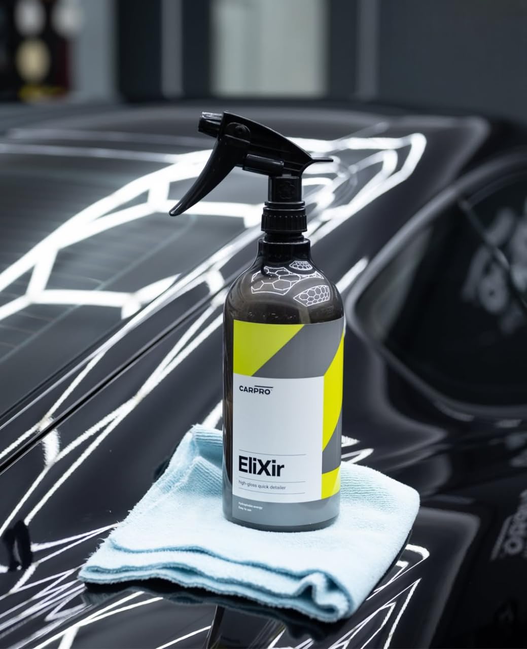 CARPRO EliXir on black paint revealing deep gloss and enhanced water beading