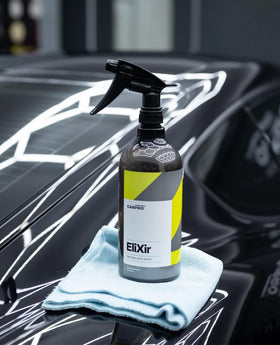 CARPRO EliXir on black paint revealing deep gloss and enhanced water beading
