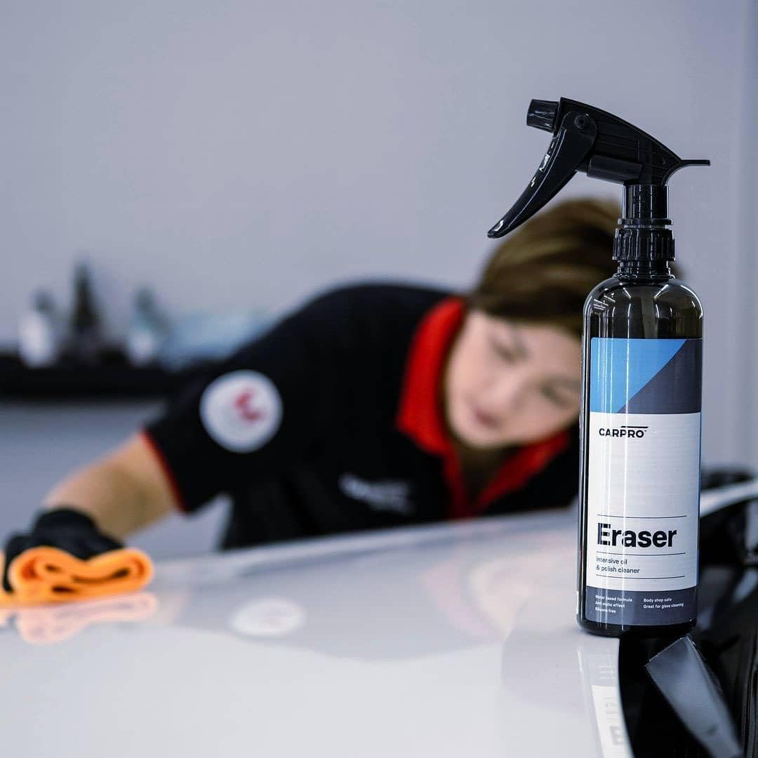Microfiber wiping treated paint with CARPRO Eraser for clean finish