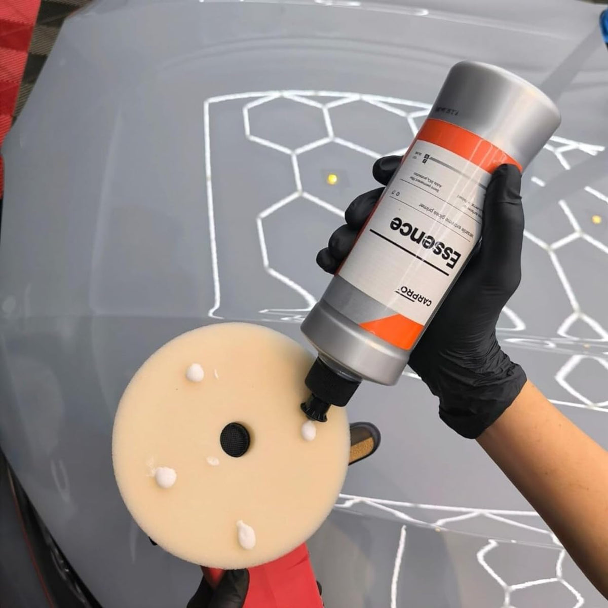 CARPRO Essence application pad in use demonstrating smooth polishing action