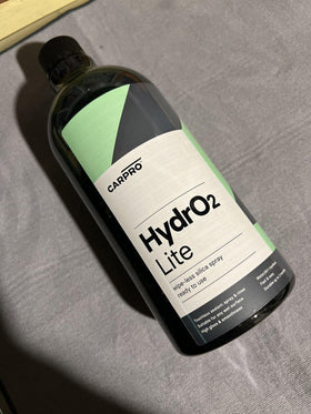 CARPRO HydrO2 Lite liter next to a water bottle for size and volume comparison