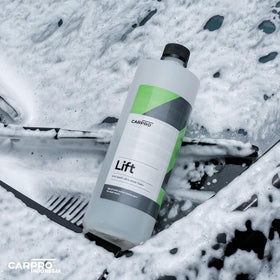 CARPRO thick foam clinging to car hood, aiding dirt breakdown safely