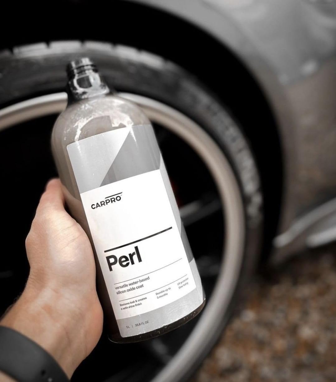 CARPRO PERL being applied to tire showing restored color and protection