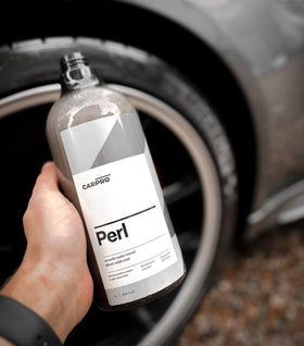 CARPRO PERL being applied to tire showing restored color and protection