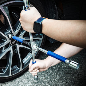CARTMAN wrench beside ruler for scale showing compact 16-inch length for trunk storage