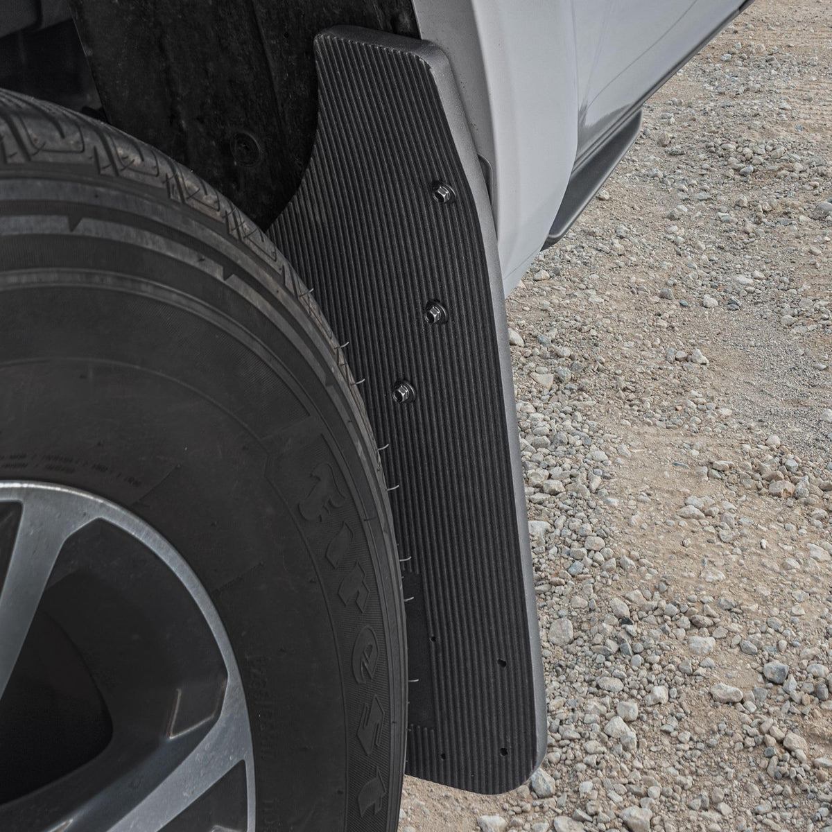 CAT mud flap installed at front wheel deflecting road debris