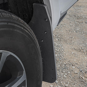 CAT mud flap installed at front wheel deflecting road debris