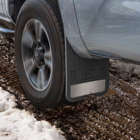 CAT mud flap beside a ruler demonstrating 19 by 11 inch size