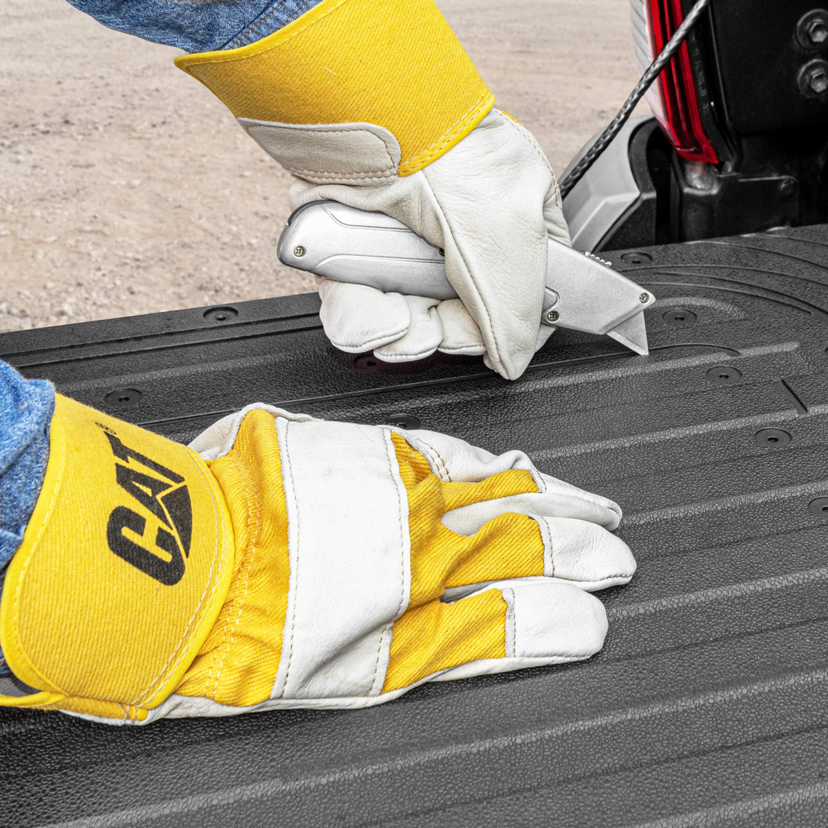 CAT tailgate mat installed on a pickup tailgate delivering a stable work surface