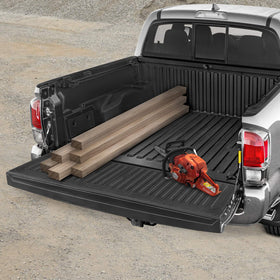 CAT tailgate mat in a worksite setting demonstrating rugged everyday use