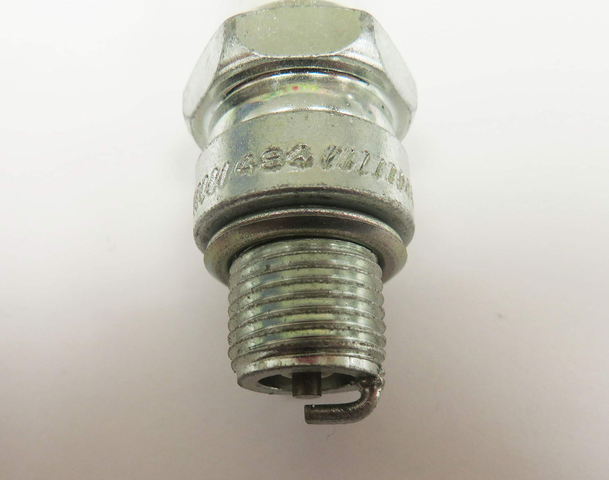 beseloa Champion QL77JC4 installed in outboard motor during maintenance showing reliable ignition replacement