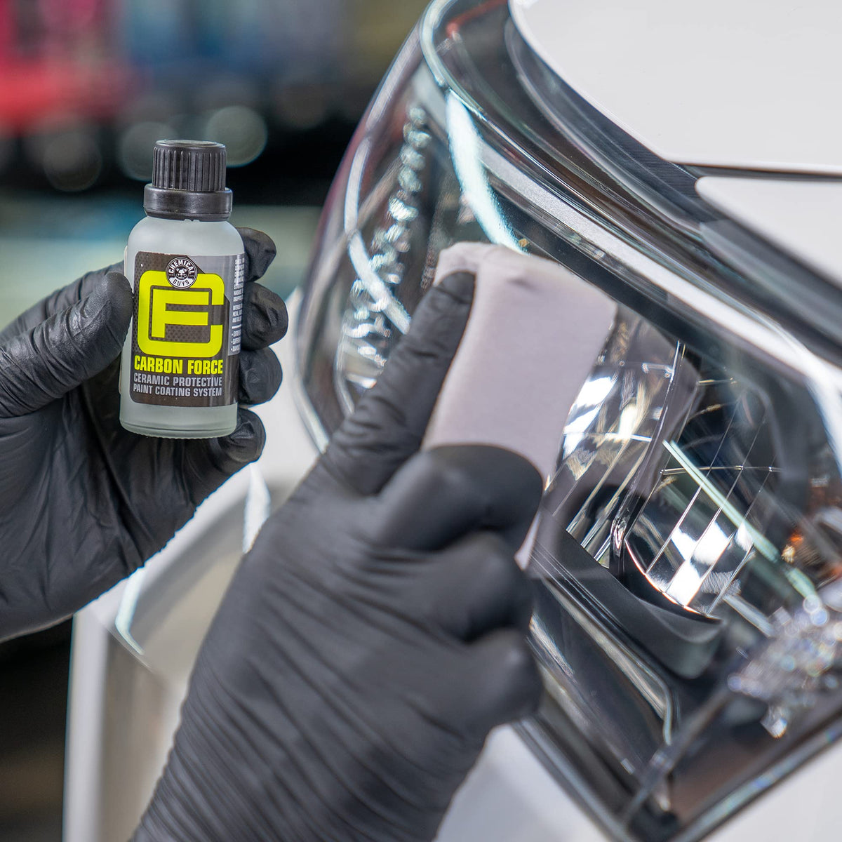Chemical Guys applying coating to headlight lens illustrating restored clarity and protection