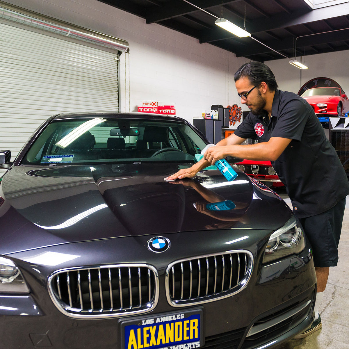 Chemical Guys clay bar and luber used on car door for smooth finish