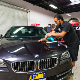 Chemical Guys clay bar and luber used on car door for smooth finish