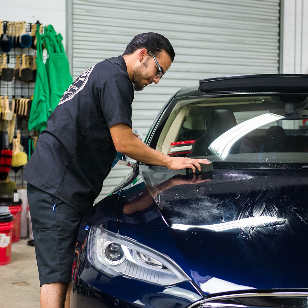 Chemical Guys clay block in use on car panel showing safe contaminant removal