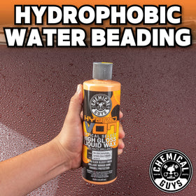 Chemical Guys bottle on a garage bench with tools suggesting professional detailing use