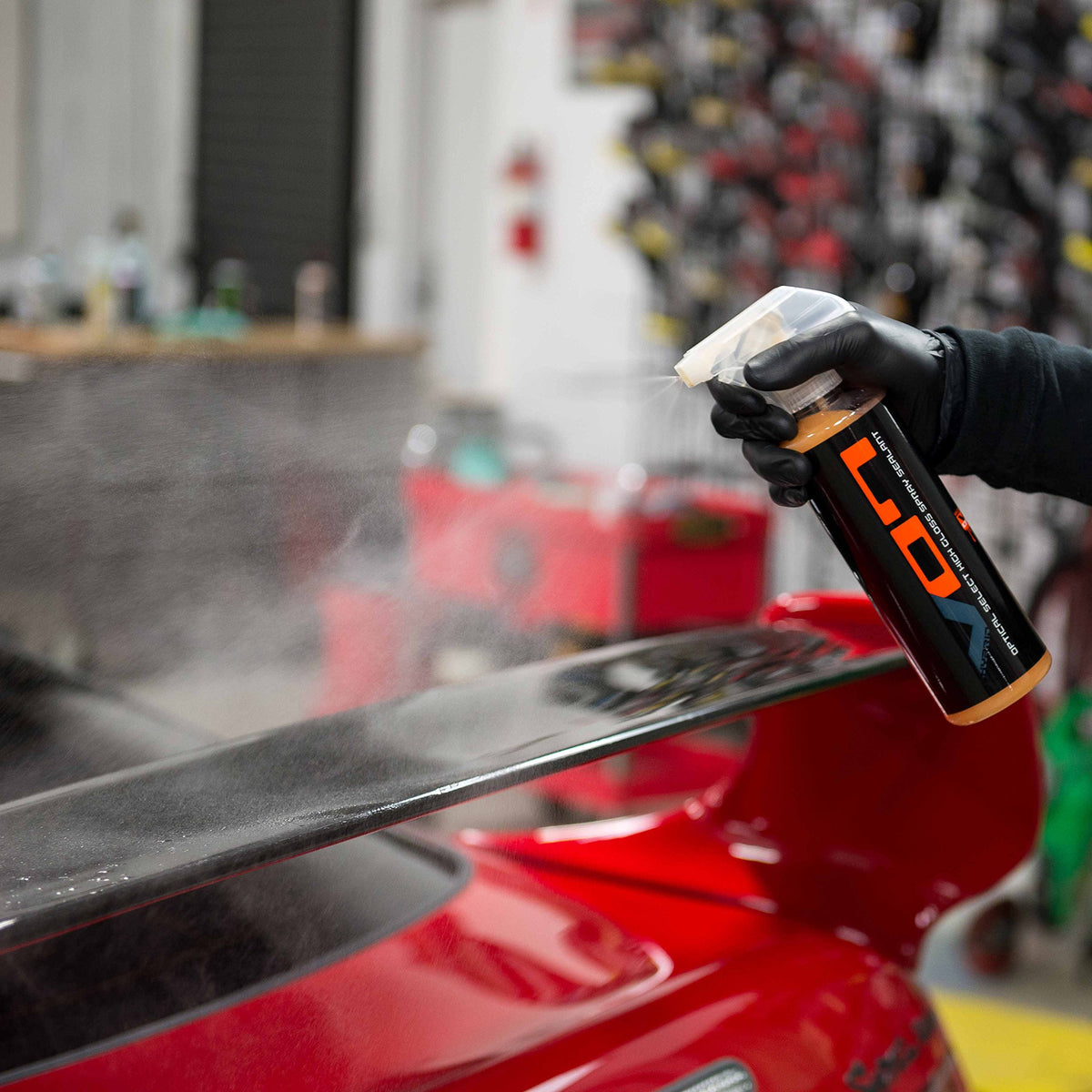 Chemical Guys Hybrid V7 being sprayed onto a microfiber for safe application