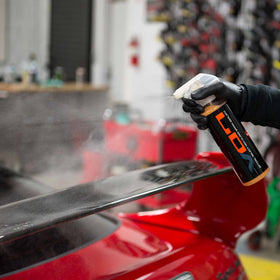 Chemical Guys Hybrid V7 being sprayed onto a microfiber for safe application