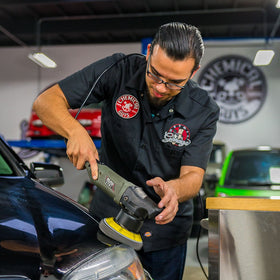 Chemical Guys polisher in use on car door demonstrating defect removal