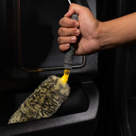 Chemical Guys small brush in use cleaning caliper and tight spots