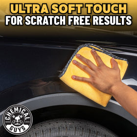 Chemical Guys towel wiping car door paint illustrating swirl-free finish protection