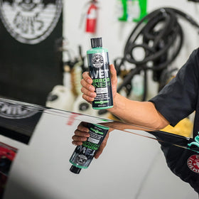 Chemical Guys being applied to car panel with pad showing quick gloss improvement benefit