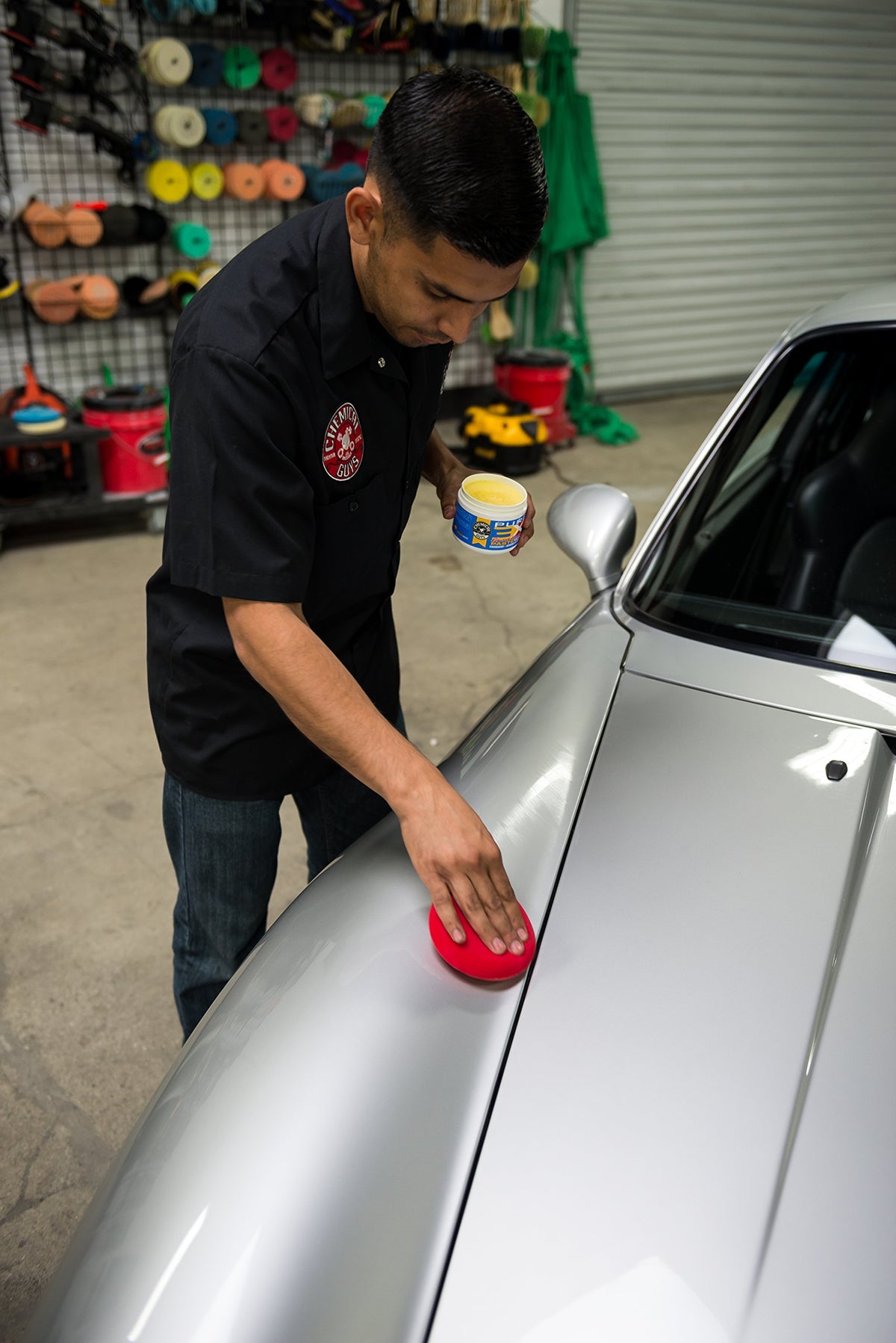 Chemical Guys applying paste wax to car panel for deep gloss
