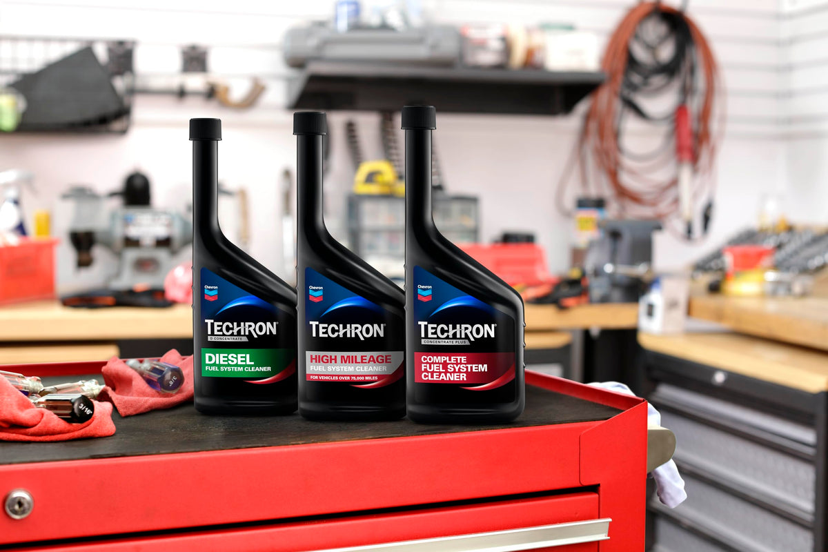 Chevron Techron being poured into fuel filler demonstrating simple, effective dosing