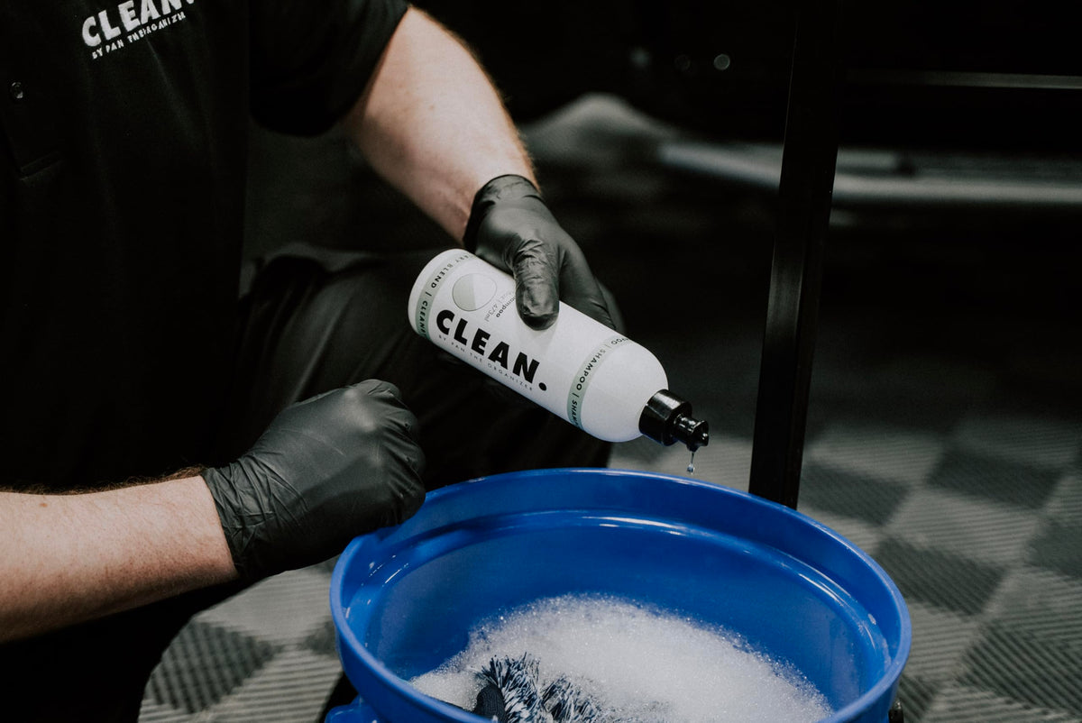 CLEAN. shampoo in use on car panel with foam rinsing clean, protecting finish