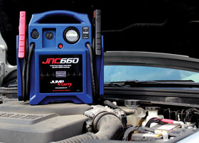 Clore Automotive JNC660 jump-starting a car battery roadside for fast, dependable engine starts