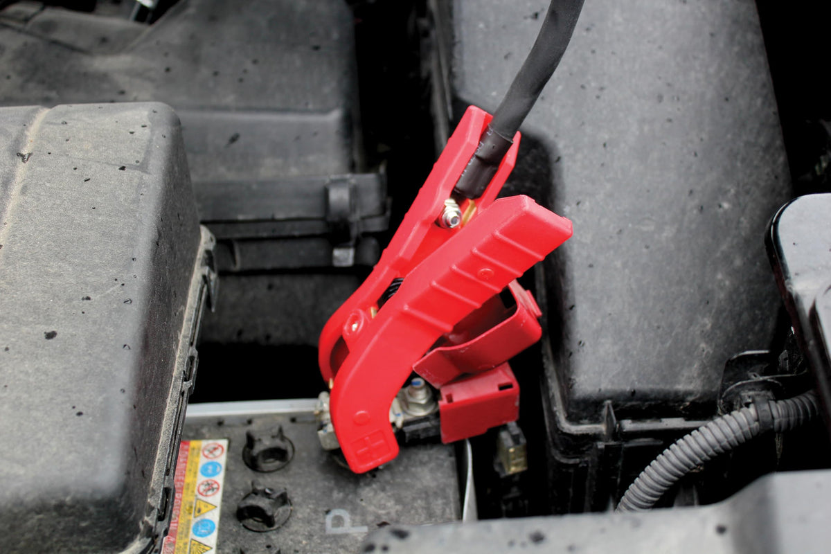 Clore Automotive jump starter in use on a car battery for fast roadside boost