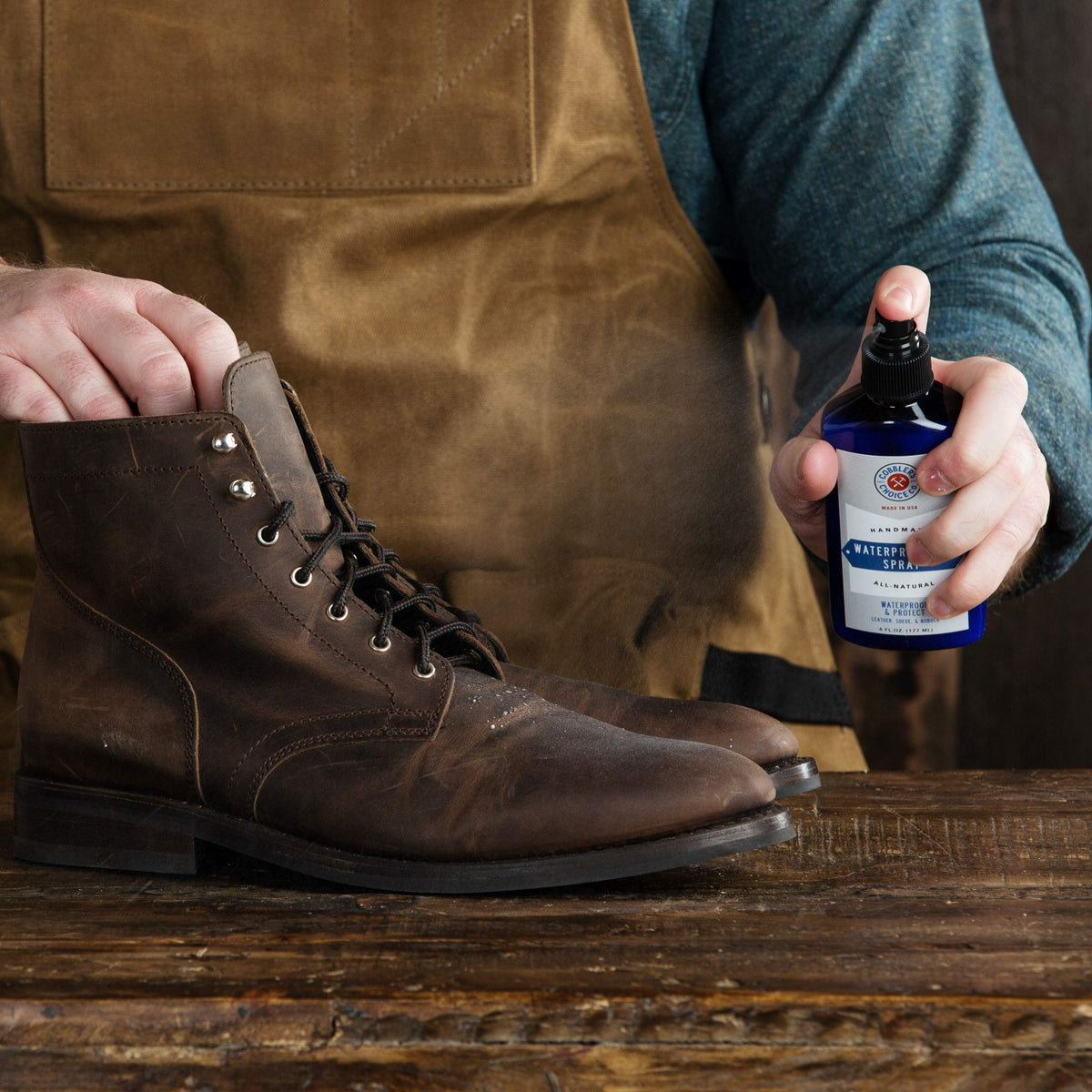 Cobbler's Choice spray being used on outdoor boot, protects against wet conditions