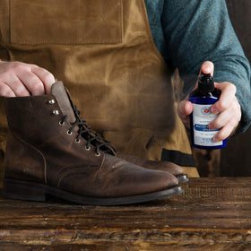 Cobbler's Choice spray being used on outdoor boot, protects against wet conditions