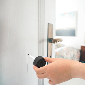 Coloch applying touch-up paint on wall showing convenient repair benefit