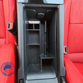 Complete Appearance lifestyle shot inside Camry showing tidy armrest and improved accessibility
