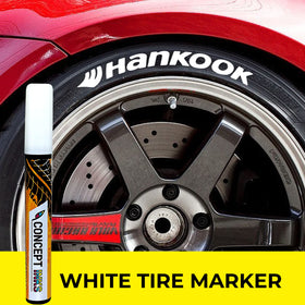 ConceptInks pen next to car wheel showing scale and amount of paint benefit