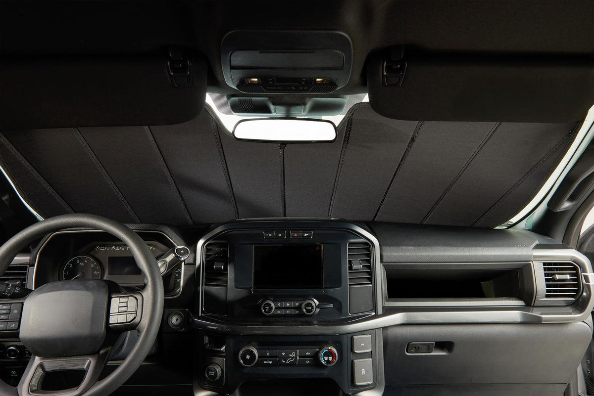 Covercraft lifestyle beach parked SUV showing shade use for cooler cabin when outdoors