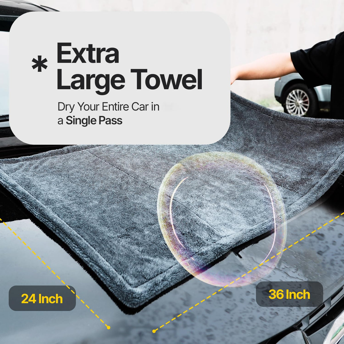 Crystal Clean towel held by hand to show 24x36 scale and quick coverage