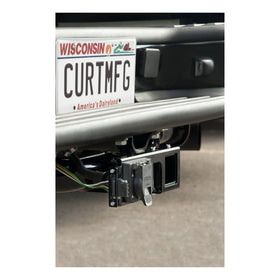 CURT in lifestyle trailer hookup scene showing organized towing setup