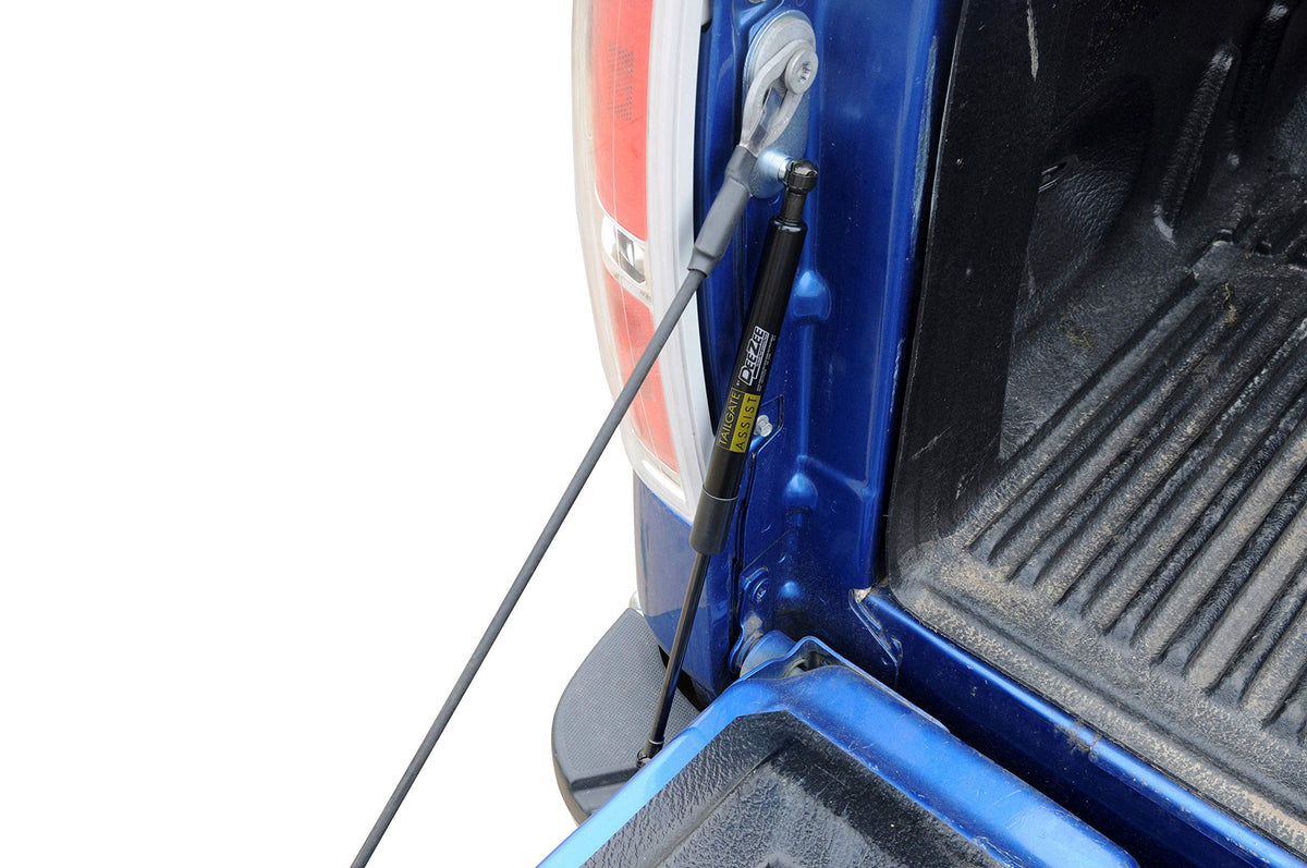 DEE ZEE tailgate assist in use with groceries loaded demonstrating easier one-handed lowering