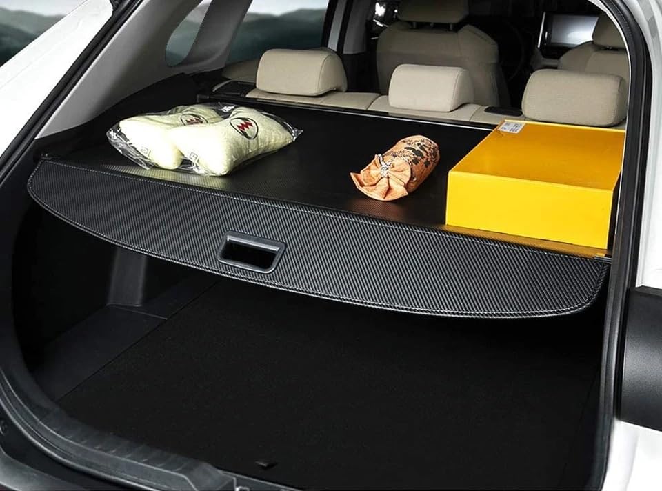 Deluden retractable cover displayed in open trunk showing scale and fit