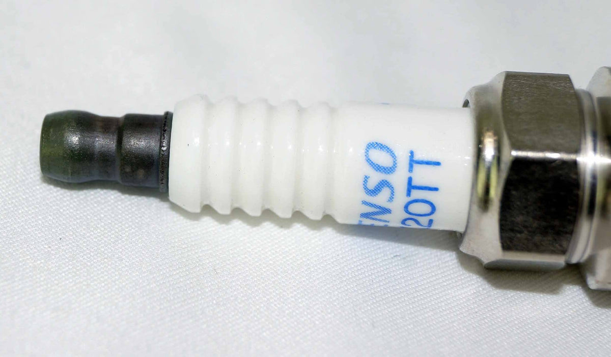 Denso spark plug installed in engine cylinder head demonstrating fitment benefit