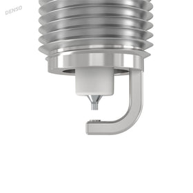 Denso spark plug beside ruler showing compact 0.7 mm electrode for focused spark