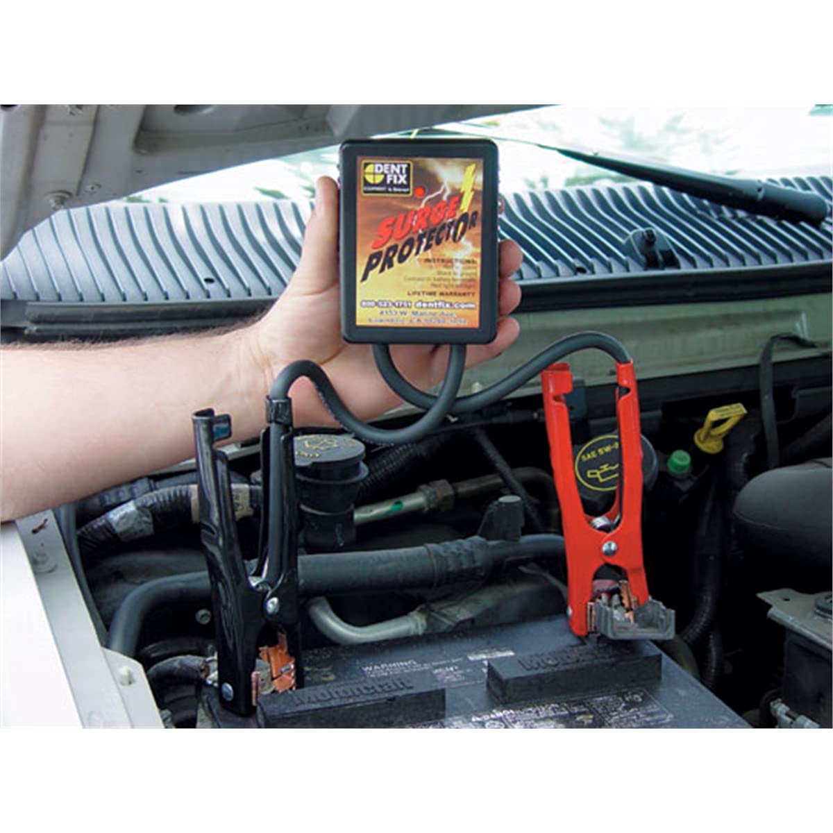 Dent Fix DF-601 installed on vehicle battery during spot welding, protecting circuits and confirming safety
