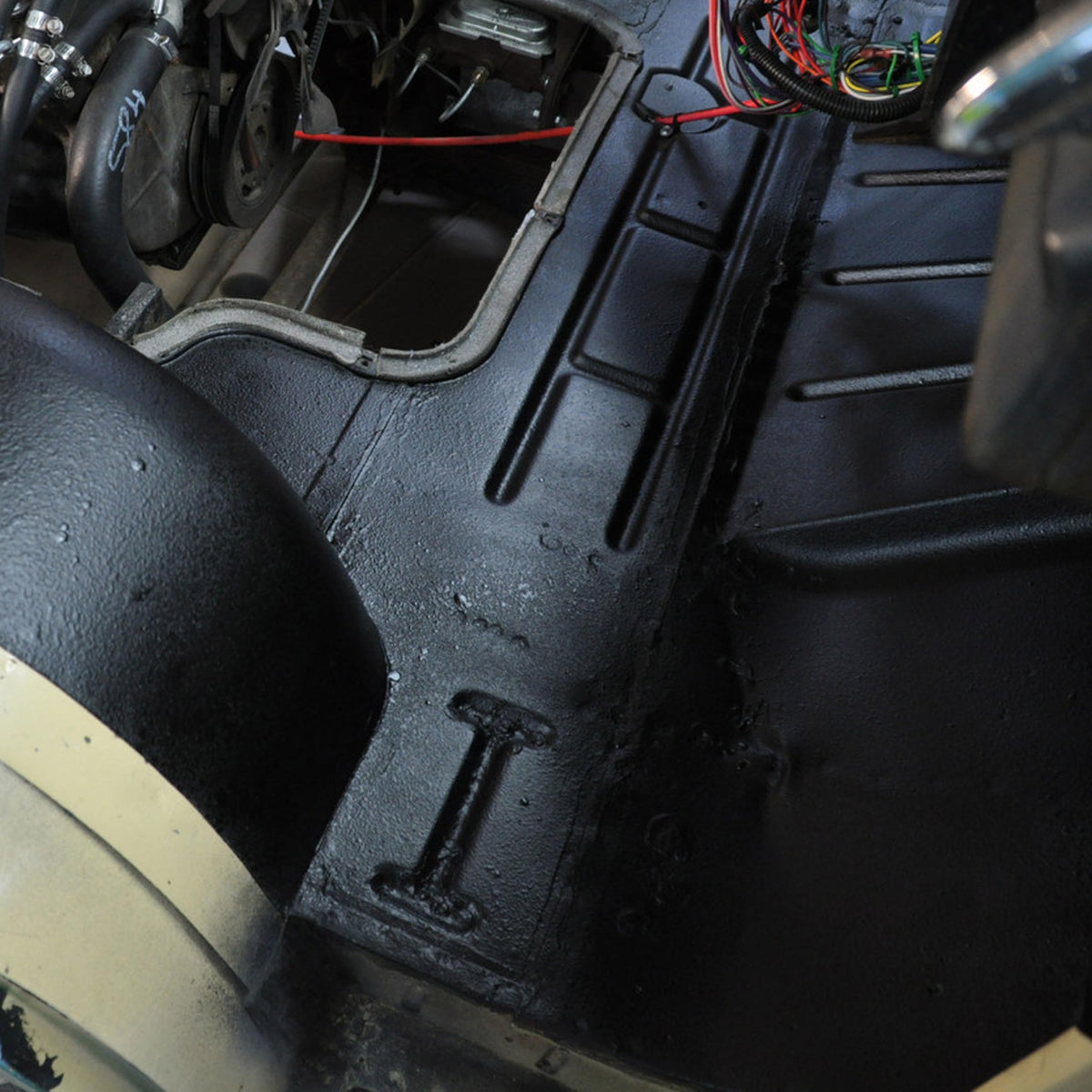 Design Engineering being sprayed inside a door panel to reduce rattles and improve audio